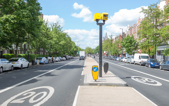 Traffic cameras monitoring vehicles on a London street with a 20 mph speed limit marked on the road, supporting AI-powered fleet safety and efficiency.